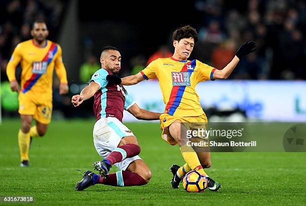 Winston Reid of West Ham United tackles Chung-yong Lee of Crystal Palace during the Premier League match between West Ham United and Crystal Palace...