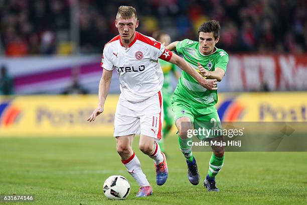 Jonas Hofmann of Moenchengladbach is challenged by Axel Bellinghausen of Duesseldorf during 3rd Place Match of Telekom Cup 2017 between Fortuna...