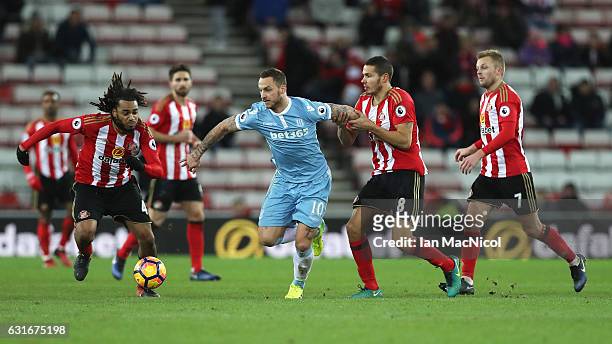 Peter Crouch of Stoke City is pulled back by Jack Rodwell of Sunderland during the Premier League match between Sunderland and Stoke City at Stadium...