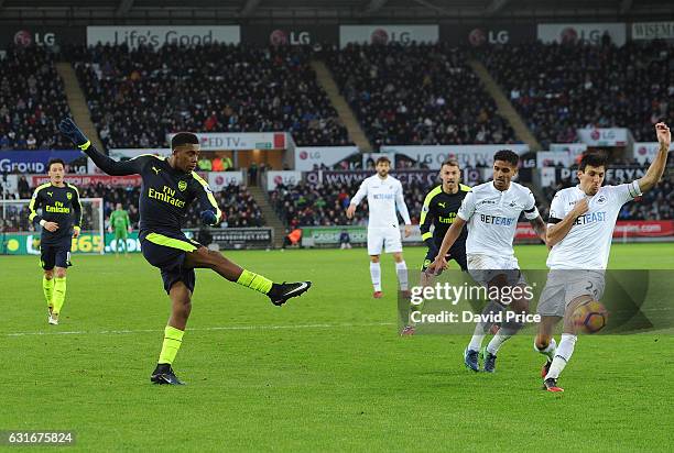 Alex Iwobi scores Arsenal's 2nd goal under pressure from Jack Cork of Swansea during the Premier League match between Swansea City and Arsenal at...