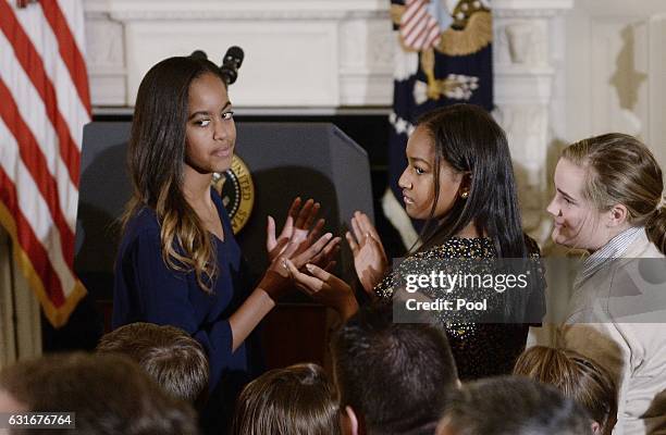 Malia Obama and Sasha Obama look on durinng a ceremony presenting the Medal of Freedom to Vice-President Joe Biden at the State Dining room of the...