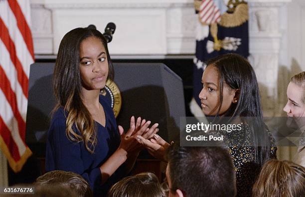 Malia Obama and Sasha Obama look on durinng a ceremony presenting the Medal of Freedom to Vice-President Joe Biden at the State Dining room of the...