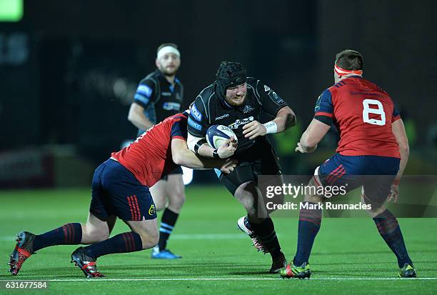 Zander Fagerson of Glasgow Warriors is tackled by C J Syander and John Ryan of Munster Rugby during the European Rugby Champions Cup match between...