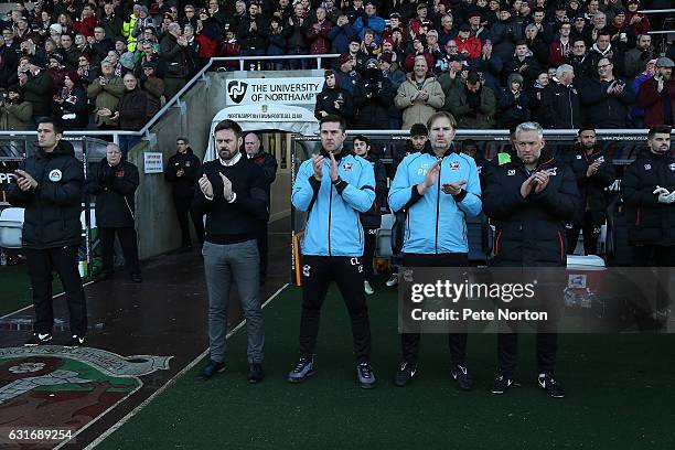 Scunthorpe United management team Graham Alexander,Chris Lucketti, Paul Musslewaite and Nick Daws observe a minutes applause in memory of former...