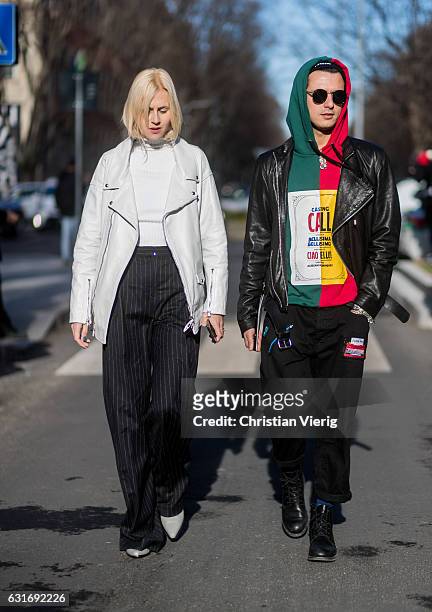 Linda Tol and Alessandro Enriquez is wearing leather jackets is seen at Armani during Milan Men's Fashion Week Fall/Winter 2017/18 on January 14,...