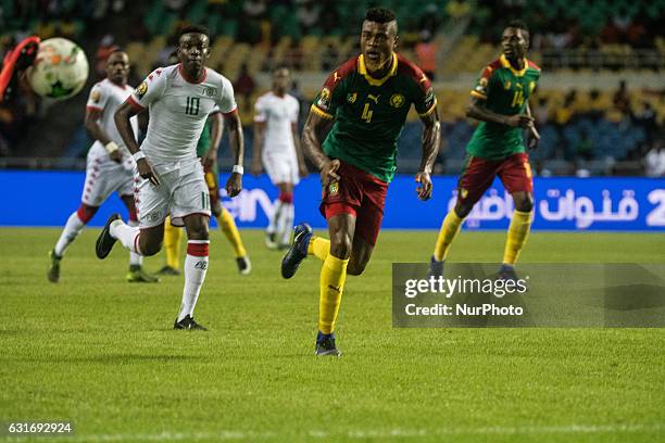 Adolphe Teikeu Kamgang and Sibiri Alain Traore running after the ball during first half at African Cup of Nations 2017 between Burkina Faso and...