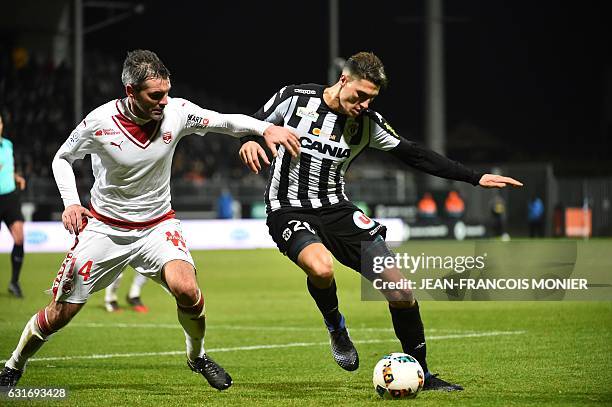 Bordeaux's French midfielder Jeremy Toulalan vies with Angers's Algerian defender Mehdi Tahrat during the French L1 football match between Angers and...