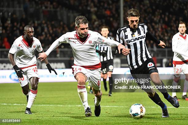 Bordeaux's French midfielder Jeremy Toulalan vies with Angers's Algerian defender Mehdi Tahrat during the French L1 football match between Angers and...