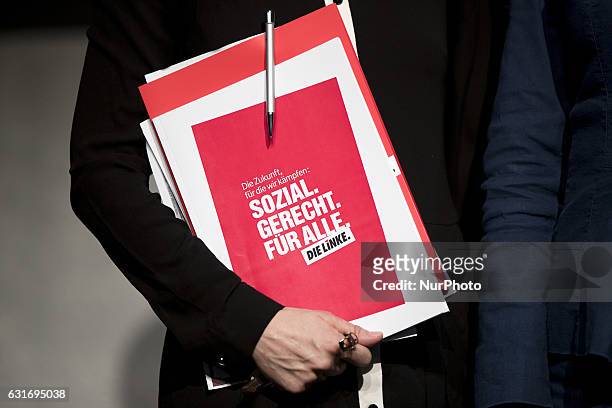 Co-leader of Die Linke party Katja Kipping holds a file reading 'The future we fight for: social, fair, for everybody. The left' at the end of a news...