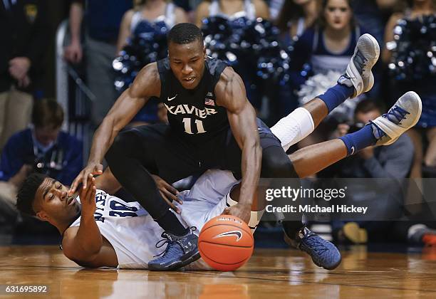 Kelan Martin of the Butler Bulldogs and Malcolm Bernard of the Xavier Musketeers battle for the ball at Hinkle Fieldhouse on January 14, 2017 in...