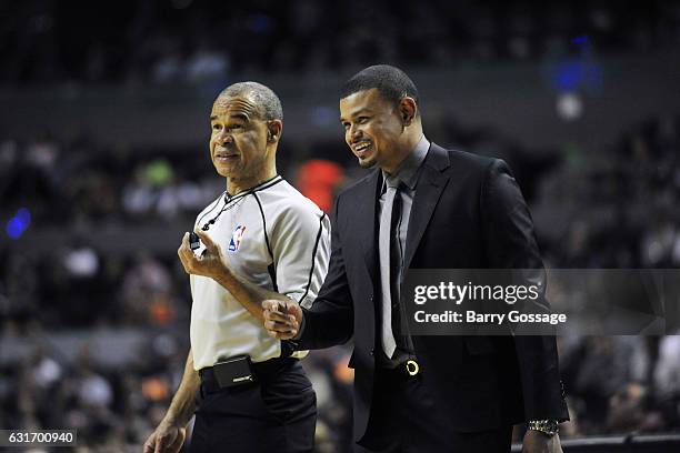 Earl Watson of the Phoenix Suns talks with referee Dan Crawford during the game against the San Antonio Spurs as part of NBA Global Games at Arena...