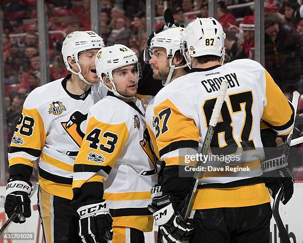 Kris Letang of the Pittsburgh Penguins celebrates his goal with teammates Ian Cole, Conor Sheary, and Sidney Crosby during an NHL game against the...