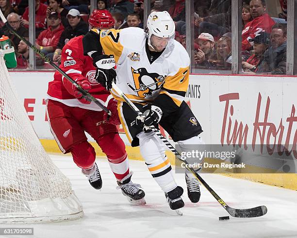 Matt Cullen of the Pittsburgh Penguins skates with the puck behind the net followed by Nick Jensen of the Detroit Red Wings during an NHL game at Joe...