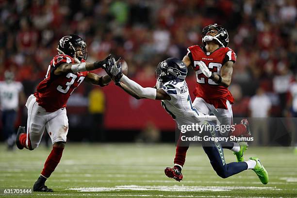 Paul Richardson of the Seattle Seahawks fails to catch the ball against Robert Alford and Ricardo Allen of the Atlanta Falcons at the Georgia Dome on...