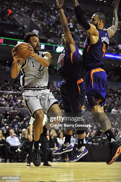 Kyle Anderson of the San Antonio Spurs drives to the basket and passes the ball against the Phoenix Suns as part of NBA Global Games at Arena Ciudad...