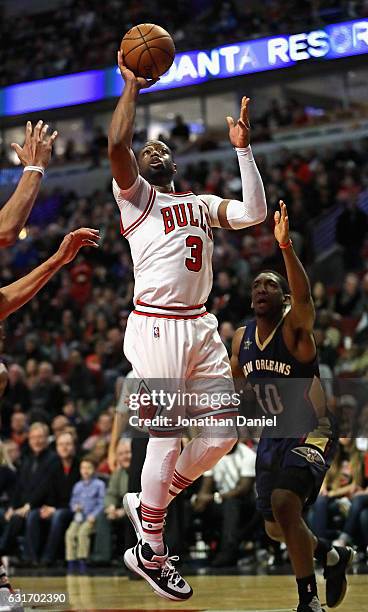 Dwyane Wade of the Chicago Bulls goes up for a shot past Langston Galloway of the New Orleans Pelicans at the United Center on January 14, 2017 in...