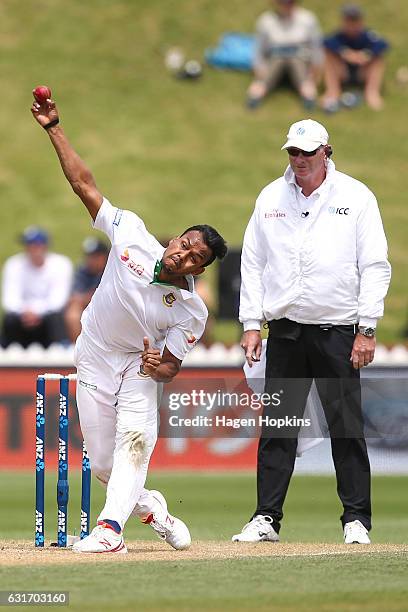 Kamrul Islam Rabbi of Bangladesh bowls while umpire Paul Reiffel of Australia looks on during day four of the First Test match between New Zealand...