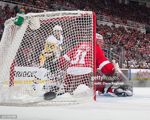 Jared Coreau of the Detroit Red Wings looks as the puck is shot wide of the goal while Patric Hornqvist of the Pittsburgh Penguins posts in front...