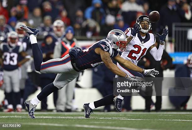 Bouye of the Houston Texans intercepts a pass in the second quarter against the New England Patriots during the AFC Divisional Playoff Game at...