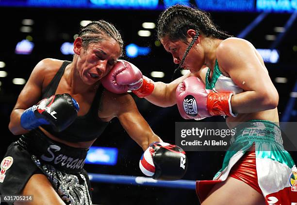 Yazmin Rivas punches Amanda Serrano during their Junior Featherweight bout at the Barclays Center on January 14, 2017 in New York City.