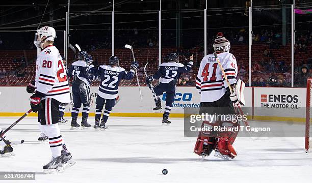 Shane Eiserman of the New Hampshire Wildcats celebrates his goal against the Northeastern Huskies during NCAA hockey at Fenway Park during "Frozen...
