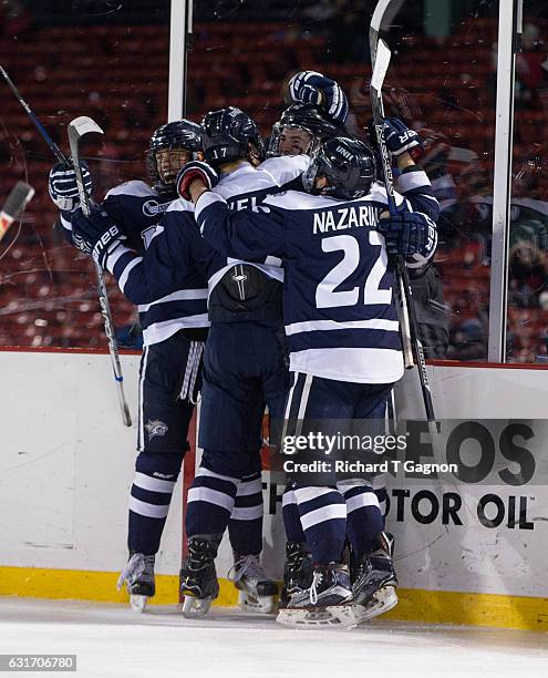 Shane Eiserman of the New Hampshire Wildcats celebrates his goal against the Northeastern Huskies with his teammates Ara Nazarian, Marcus Vela and...