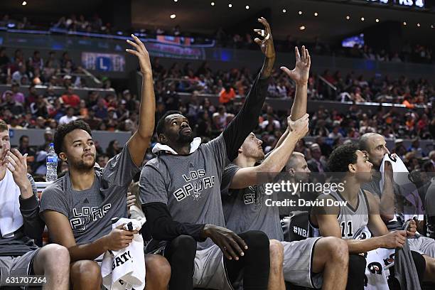 Kyle Anderson, Dewayne Dedmon and David Lee of the San Antonio Spurs celebrate the Kawhi Leonard dunk during the game against the Phoenix Suns as...