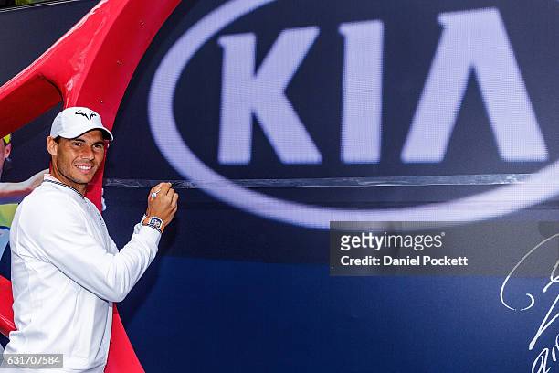 Rafael Nadal of Spain signs a string for the oversized raquet during a Kia Key handover ceremony at Garden Square in Melbourne Park January 15, 2017...