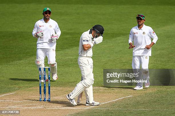 Neil Wagner of New Zealand reacts after being struck under his chin by a delivery during day four of the First Test match between New Zealand and...