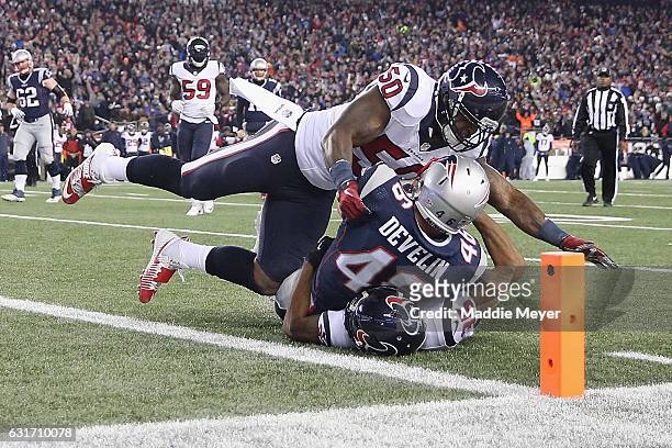 James Develin of the New England Patriots is tackled by Eddie Pleasant and Akeem Dent of the Houston Texans in the first half during the AFC...