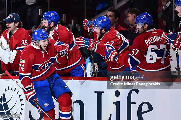 Alexei Emelin of the Montreal Canadiens reacts while celebrating his goal with teammates on the bench during the NHL game against the New York...