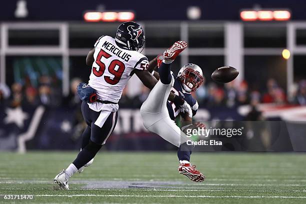 Dion Lewis of the New England Patriots misses a catch while under pressure by Whitney Mercilus of the Houston Texans in the first half against the...