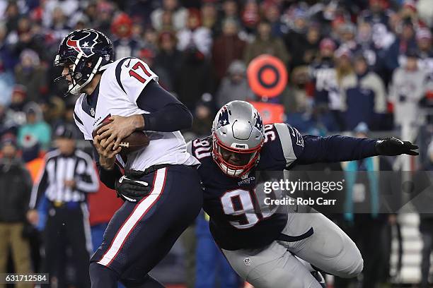 Brock Osweiler of the Houston Texans is tackled by Malcom Brown of the New England Patriots in the second half during the AFC Divisional Playoff Game...
