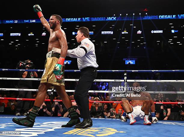 Badou Jack knocks down James DeGale in the twelfth round during their WBC/IBF Super Middleweight Unification bout at the Barclays Center on January...