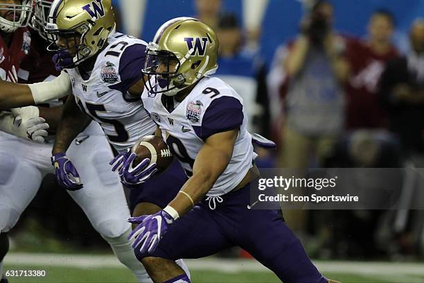 Washington Huskies running back Myles Gaskin carries the ball early in the College Football Playoff Semifinal at the Chick-fil-A Peach Bowl between...