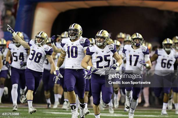 The Washington Huskies take the field for the College Football Playoff Semifinal at the Chick-fil-A Peach Bowl between the Washington Huskies and the...