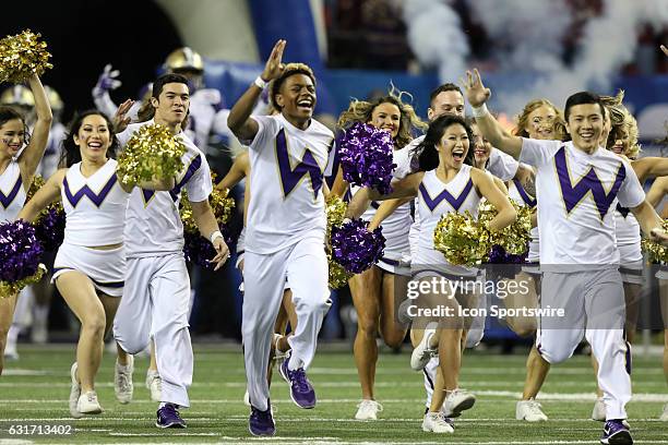 Cheerleaders lead the Washington Huskies onto the field for the College Football Playoff Semifinal at the Chick-fil-A Peach Bowl between the...