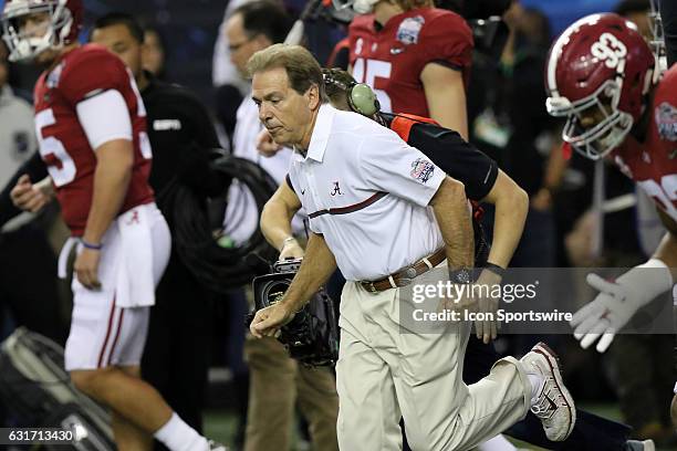 Alabama Crimson Tide head coach Nick Saban leads the team onto the field for warmups before the College Football Playoff Semifinal at the Chick-fil-A...