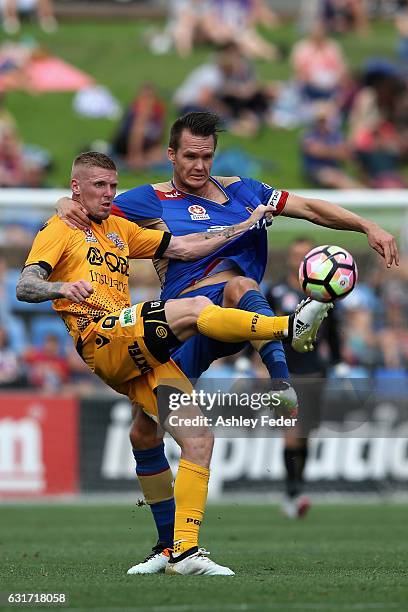 Nigel Boogaard of the Jets contests the ball against Andrew Keogh of the Glory during the round 15 A-League match between the Newcastle Jets and the...