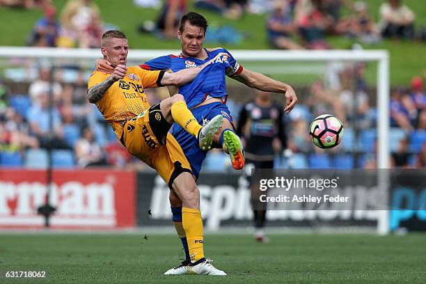 Nigel Boogaard of the Jets contests the ball against Andrew Keogh of the Glory during the round 15 A-League match between the Newcastle Jets and the...
