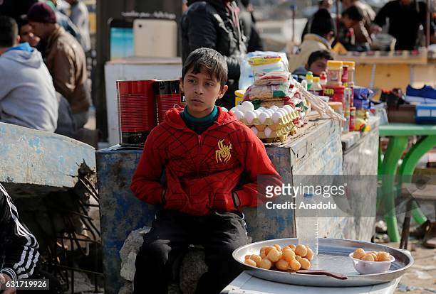 Internally relocated Iraqi people are seen at an outdoor market in Gokcheli district, which is under the control of Iraqi Army forces in eastern...