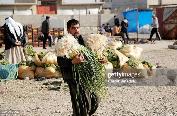 Internally relocated Iraqi people are seen at an outdoor market in Gokcheli district, which is under the control of Iraqi Army forces in eastern...