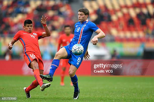 Esteban Pavez of Chile and Bjorn Bergmann Sigurdarson of Iceland vie for the ball during the final match of 2017 Gree China Cup International...