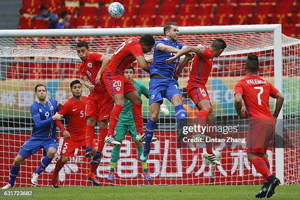 Esteban Pavez and Guillermo Maripan of Chile competes for the ball with Kari Arnason of Iceland during the final match of 2017 Gree China Cup...