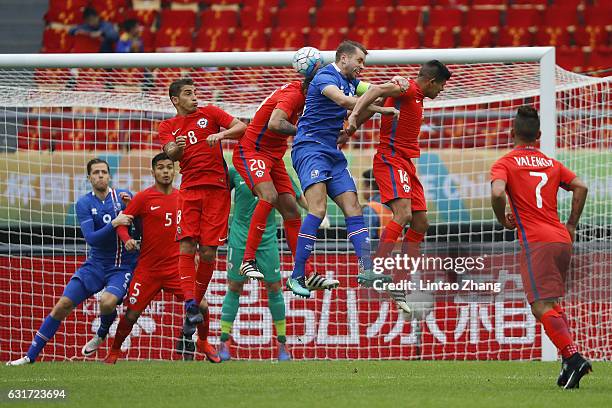 Esteban Pavez and Guillermo Maripan of Chile competes for the ball with Kari Arnason of Iceland during the final match of 2017 Gree China Cup...
