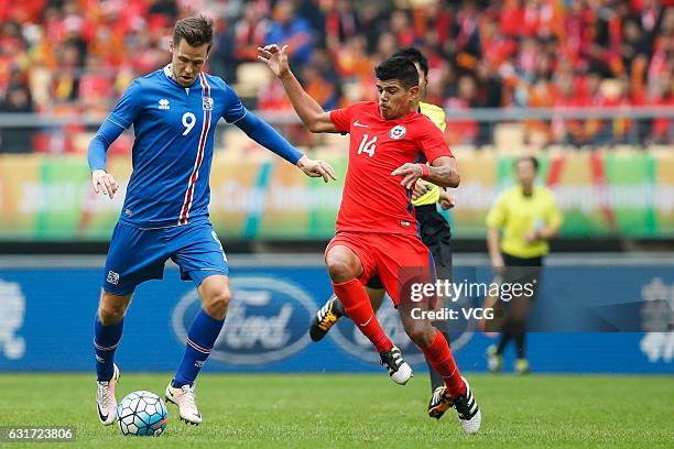 Esteban Pavez of Chile and Kjartan Finnbogason of Iceland vie for the ball during the final match of 2017 Gree China Cup International Football...