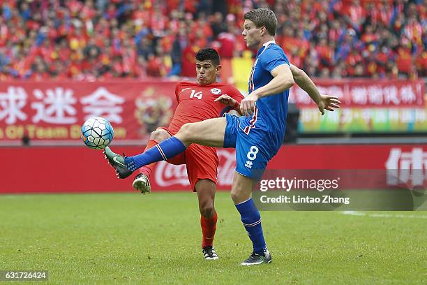 Esteban Pavez of Chile competes for the ball with Bjorn Bergmann Sigurdarson of Iceland during the final match of 2017 Gree China Cup International...
