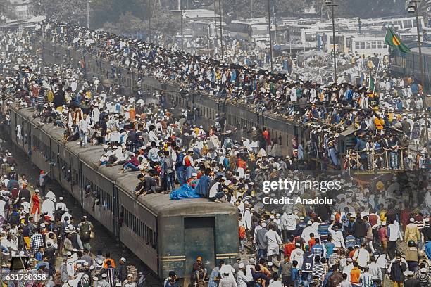 Bangladeshi Muslim devotees climb on a train to take part in Akheri Munajat, the final prayers at the World Muslim Congregation Biswa Ijtema, at...