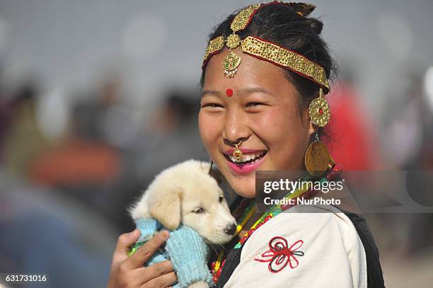 Smilling Portrait of Nepalese Magar girl in a traditional attire during prade of the Maghi festival celebrations, or the New Year of the Tharu...