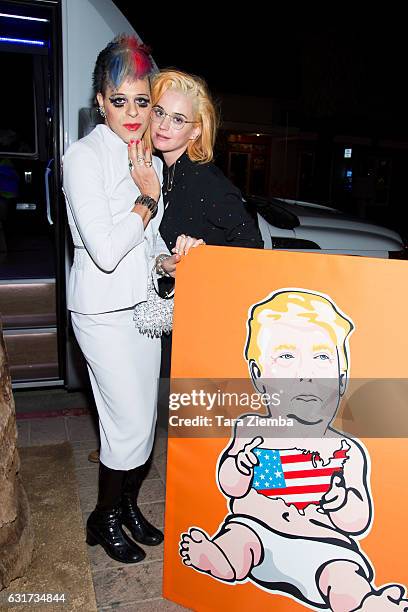 Personality/pop artist Sham Ibrahim and singer Katy Perry pose for a photo with a Donald Trump portrait at Oscar's on January 14, 2017 in Palm...